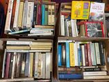 boxes of books are stacked on top of each other in a room