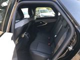 a black car with the door open and the seats down