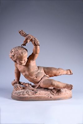 statue of a boy on a rock with a bird on his shoulder