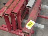 un banc rouge qui se trouve au milieu d'un parking