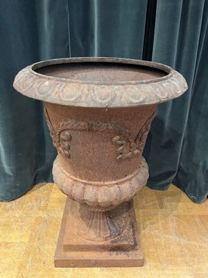 a large vase that is sitting on a wooden stand