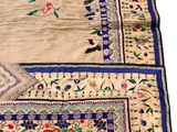 an image of a white and blue rug with flowers on it