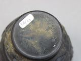 a black vase that has a label on it