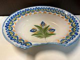 a small bowl with a leaf on it on a table