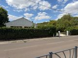 a fence on the side of the road next to the street