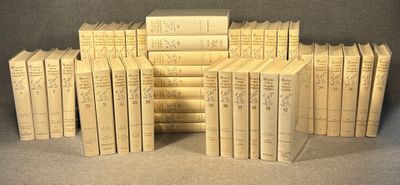 many books stacked on top of each other on a table