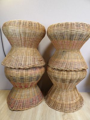 two wicker stools are stacked on top of each other on a wooden table