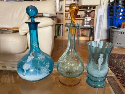three glass vases sitting on a table in a living room