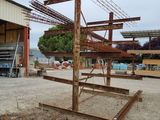 a metal structure in the middle of a dirt field
