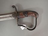 a very old sword that is laying on a table