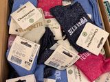 many pairs of socks in a box with labels on them