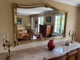 a table with a vase on it and a mirror on the wall