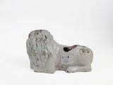 a small statue of a lion on a white surface