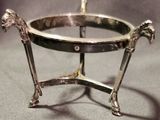 a silver plate with a horse on it on a table