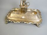 a silver plate with a candle holder on it