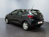 the back of a black car in a room with a white wall