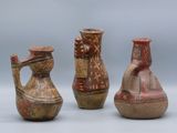 three vases with designs on them sitting next to each other