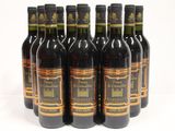 six bottles of wine are lined up in a row on a white surface