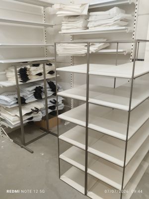 a white shelving with lots of white items on it