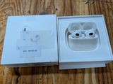 an apple airpods are sitting in a box on a wooden table