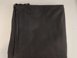 a black bag sitting on a table next to a clock