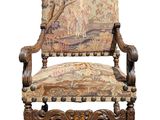 an old chair with a tapestry on the back of it