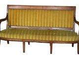 a wooden bench with a yellow striped upholstered seat