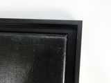 a close up of a picture of a black frame on a white wall