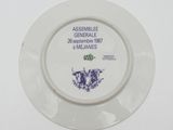 a white plate with a purple and blue design on it