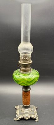 a close up of a glass lamp on a metal stand