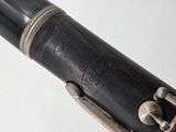 close up of a clarinet with a black body and silver keys