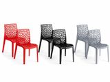 three different colored plastic chairs sitting next to each other on a white surface