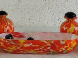 three vases and a bowl sitting on a table