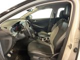 the interior of a car with the door open and the driver ' s seat down