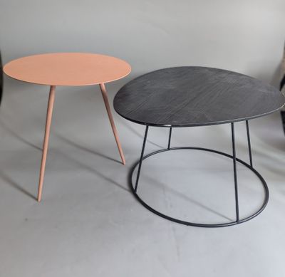 two tables with different colored tops sit side by side on a white surface