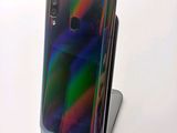 the back of a black phone with a rainbow - colored back