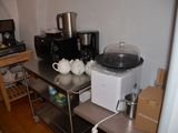 a small kitchen with a microwave, coffee maker, and other appliances