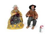 two figurines of a man and a woman sitting next to each other
