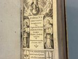 someone is holding an old book with a picture of a woman on it