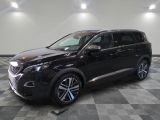 the black suv is parked in the garage on a checkered floor