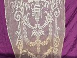 an image of a purple blanket with a white lace design on it
