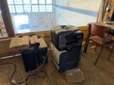 a pile of office equipment sitting on the floor in a room