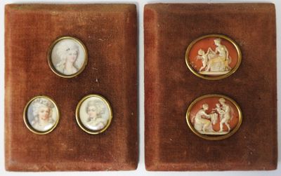 two antique cameos of women and children in a velvet case