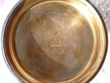 a metal bowl that is sitting on a table