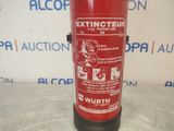 a red fire extinguisor sitting on a table