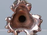 a metal object with a hole in it on a table