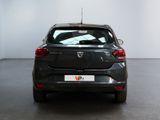 the back end of a black car in a room with a white wall