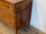 a wooden dresser with three drawers on it in a room