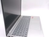 a silver laptop with a black keyboard on a white surface