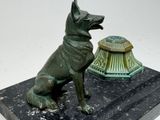 a statue of a dog sitting next to a lamp